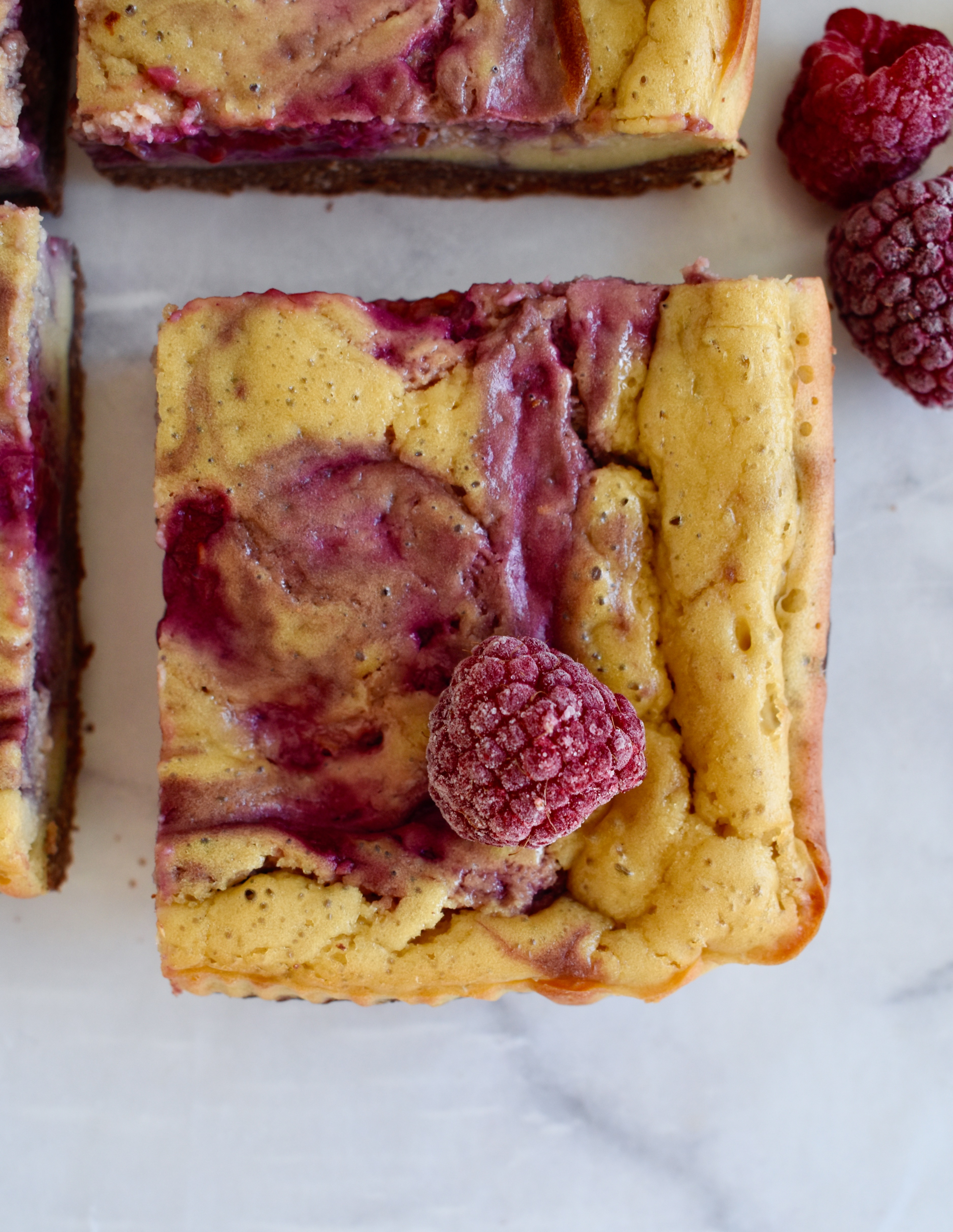 gluten free raspberry cheesecake bars with brownie crust