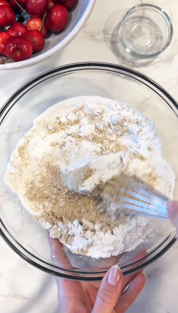 mixing dry ingredients for gluten free chocolate chip cookies with cherries