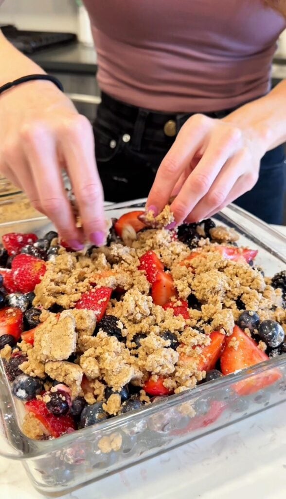 adding gluten free crumble topping to fruit